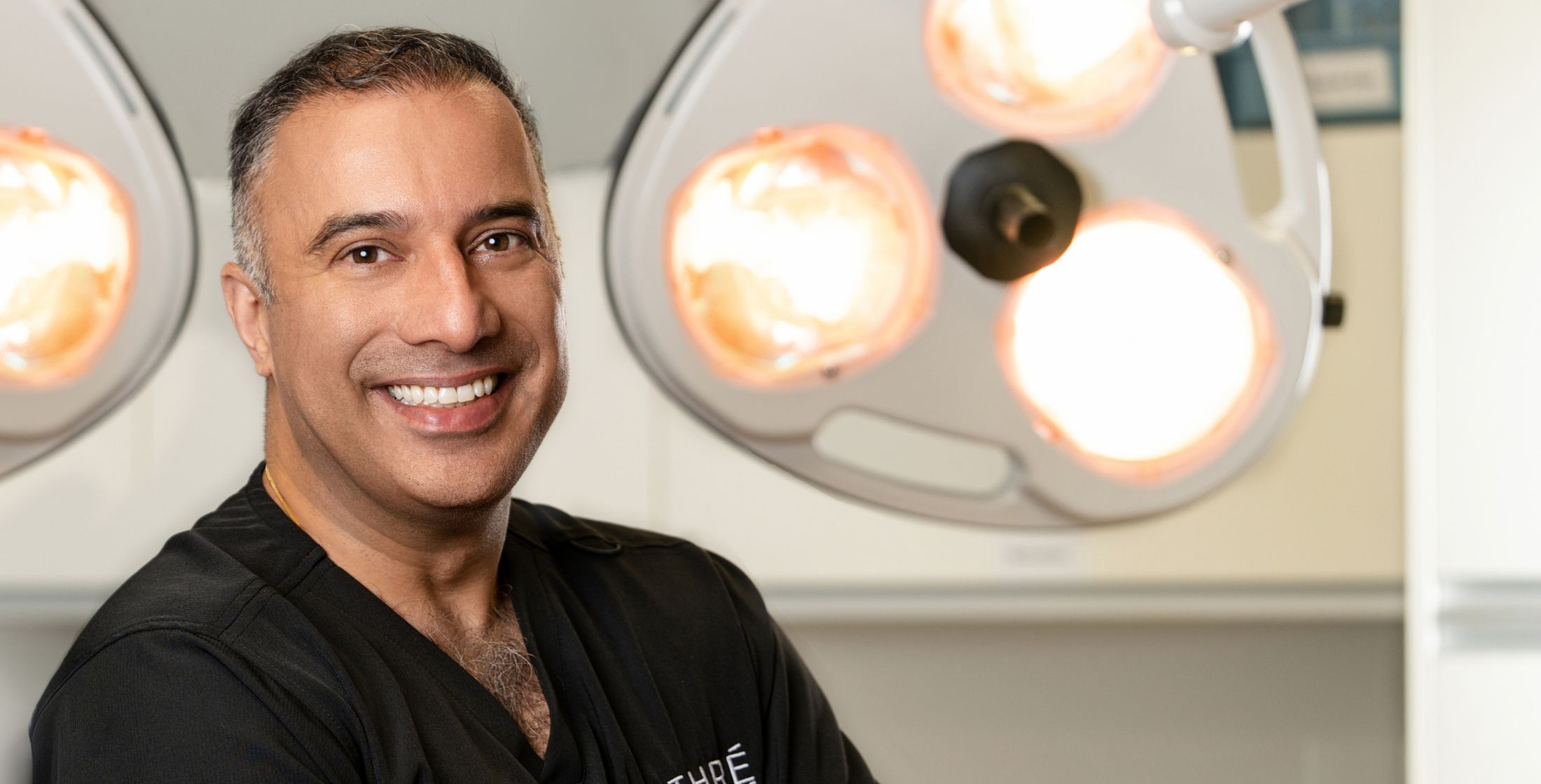 Smiling medical professional in an operating room.