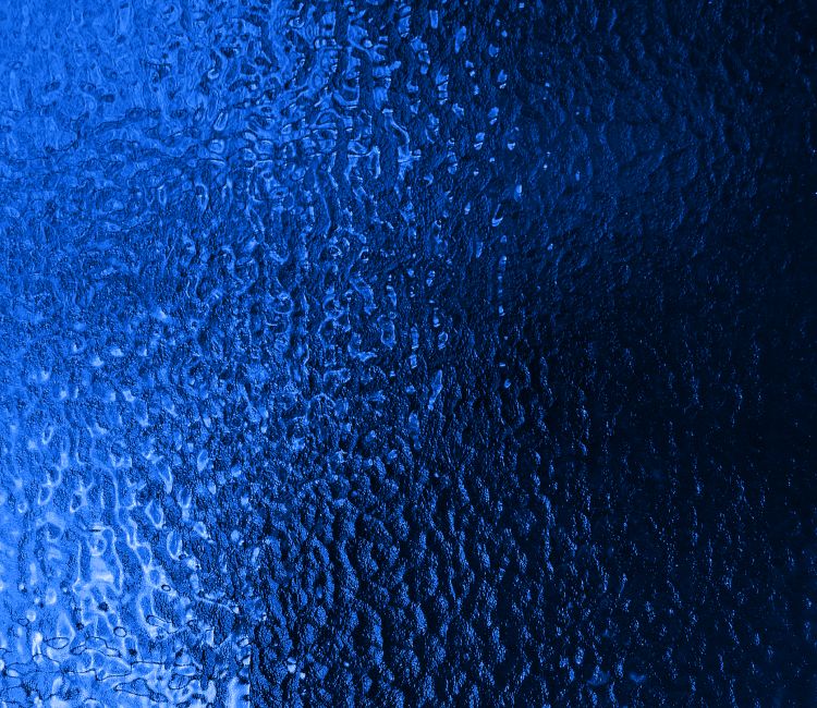 Abstract blue textured surface with water droplets.