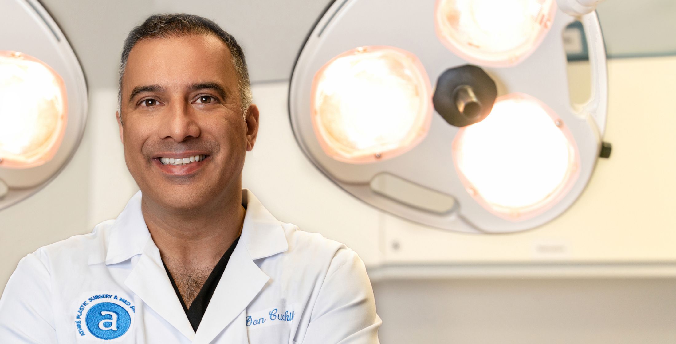 Smiling doctor in surgical environment.