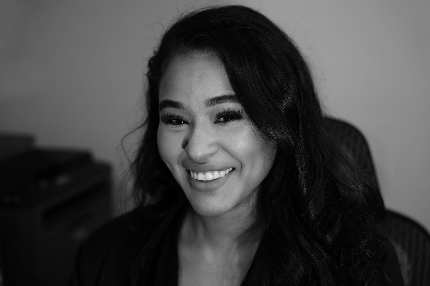 Smiling woman with long, dark hair.