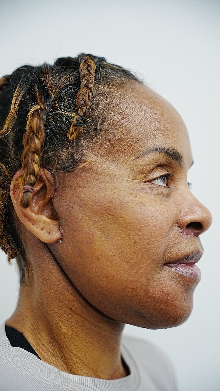 Profile of a woman with short curly hair.