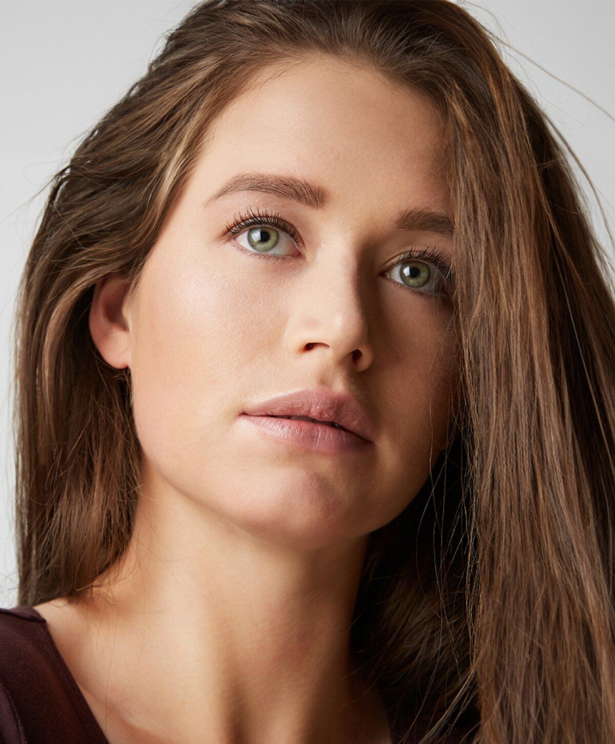 Close-up of a young woman with long hair.