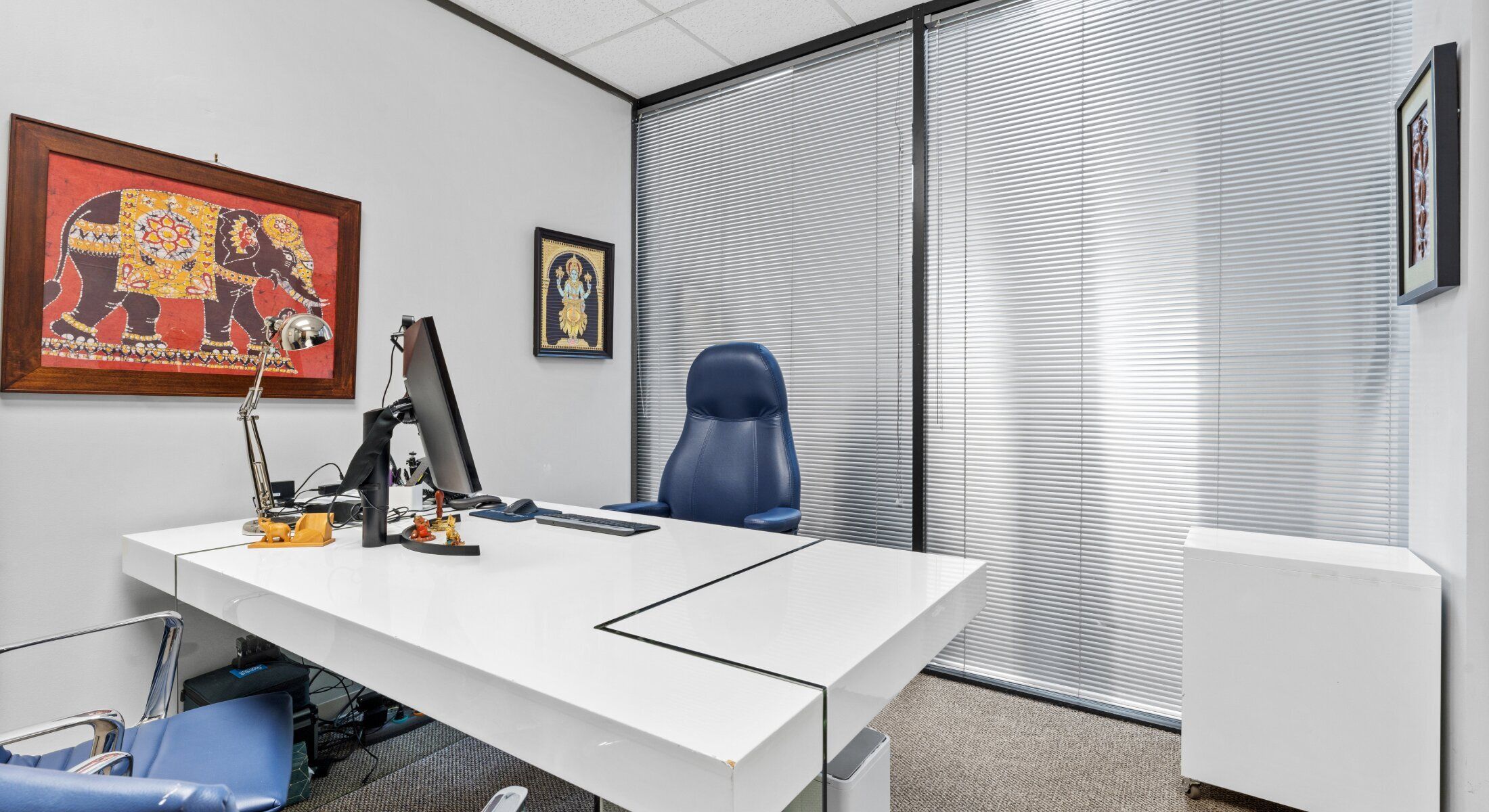 Modern office with decorative elephant artwork.